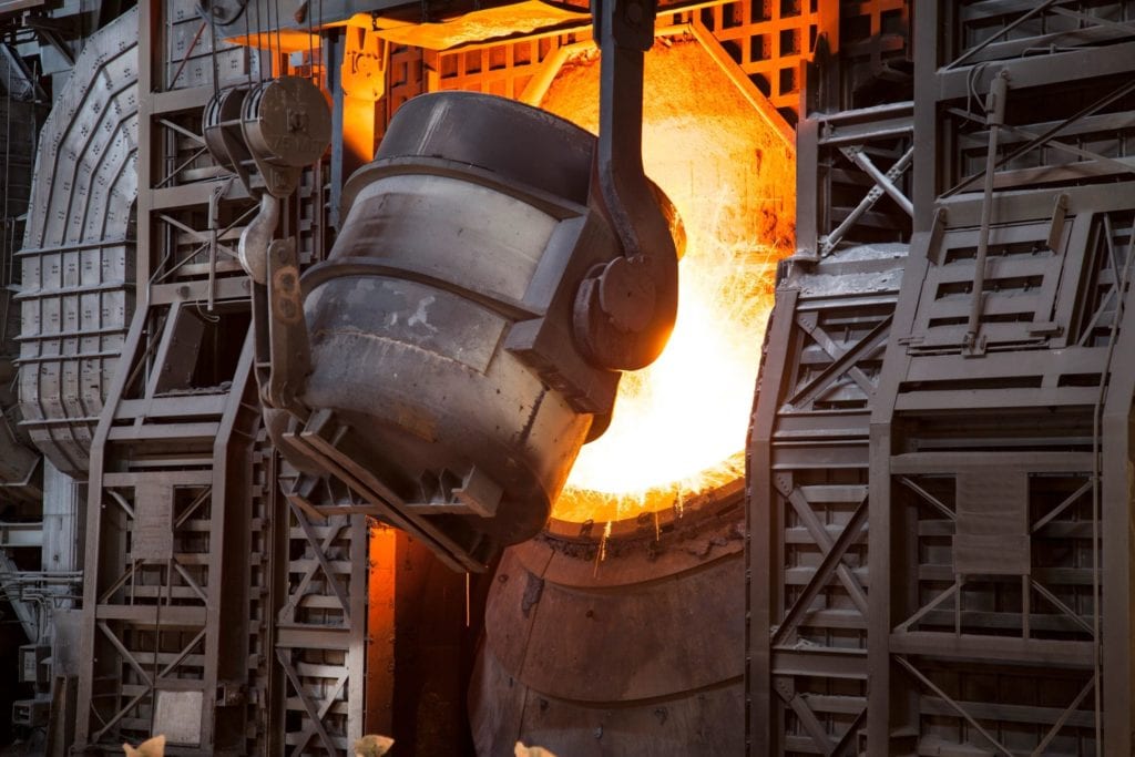 Molten metal pouring from industrial ladle